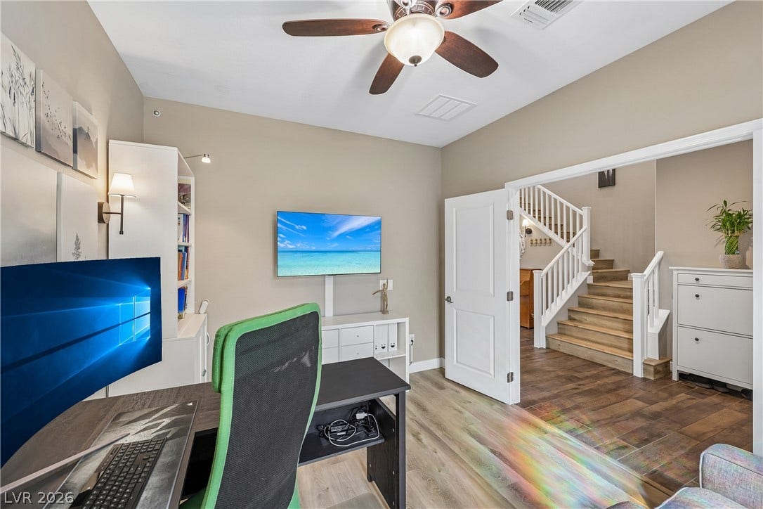 9490 Wild Valley Avenue, Las Vegas, NV 89148 Double doors open to a versatile home workspace adjacent to the main staircase.