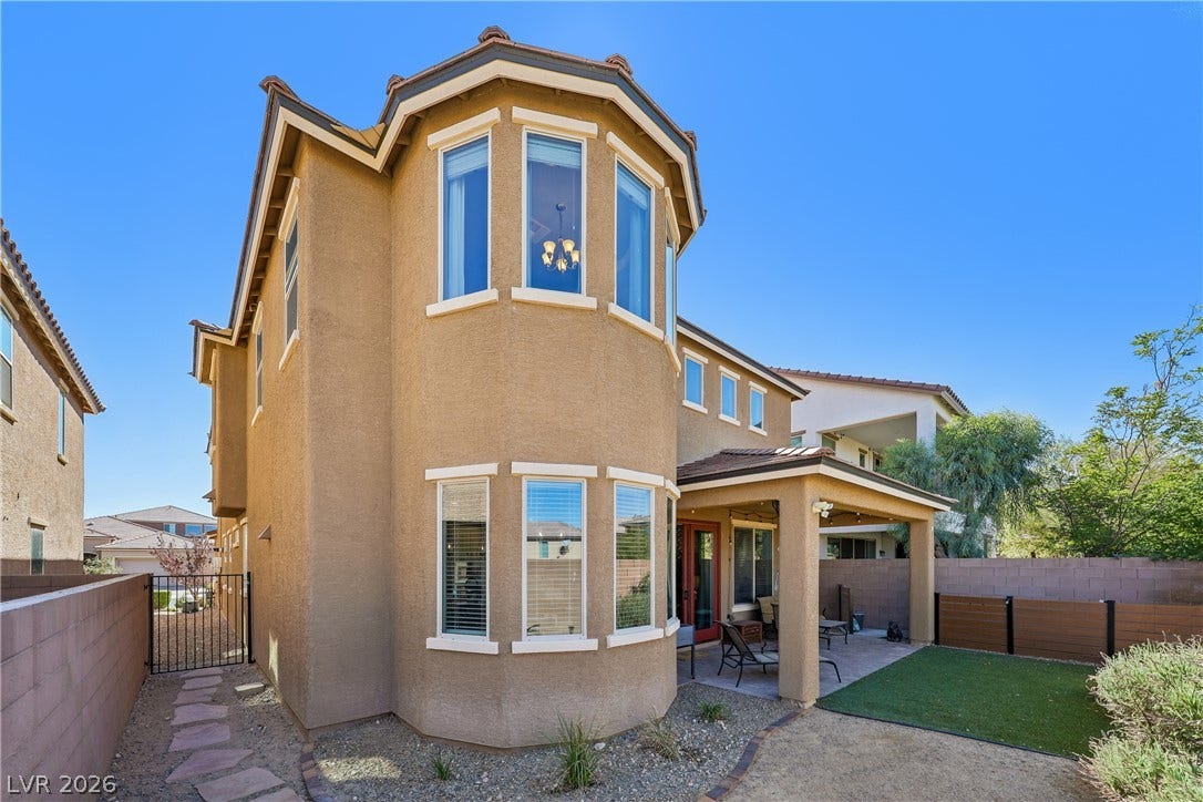 9490 Wild Valley Avenue, Las Vegas, NV 89148 Mediterranean-inspired architectural details define this multi-level stucco home with a covered patio.