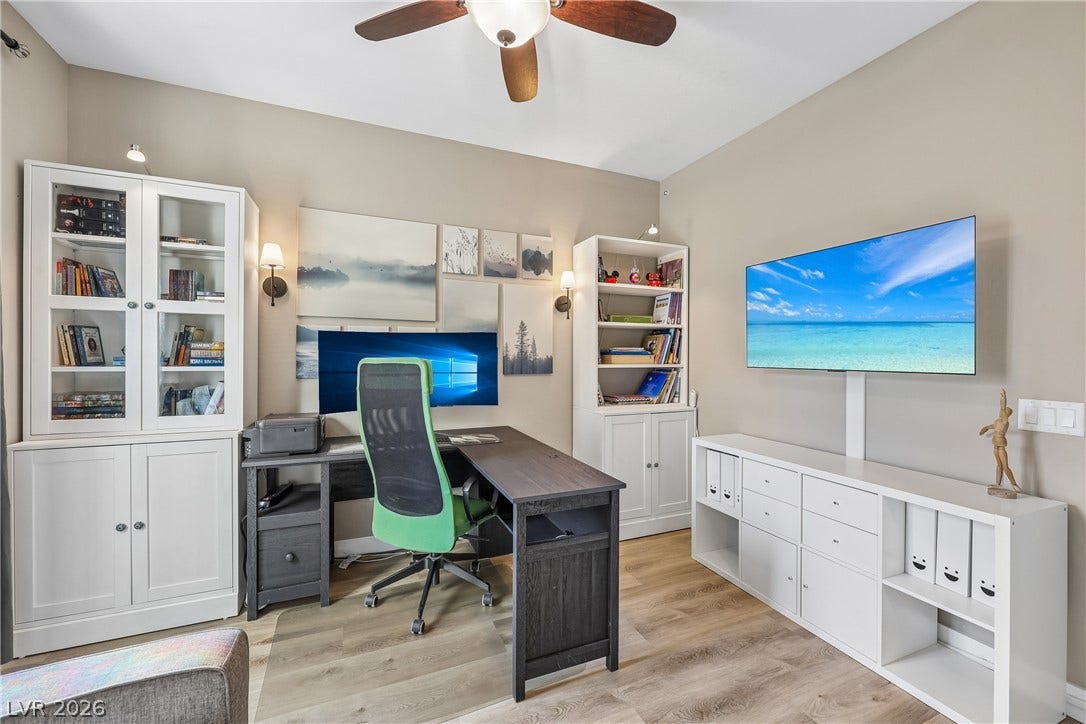 9490 Wild Valley Avenue, Las Vegas, NV 89148 Smooth wood-look flooring and custom built-in cabinetry define this versatile workspace.