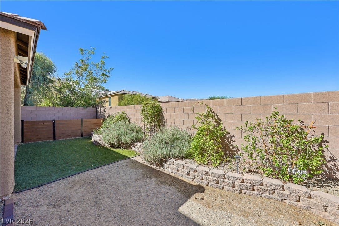 9490 Wild Valley Avenue, Las Vegas, NV 89148 A private walled backyard features low-maintenance ground cover and raised garden beds.