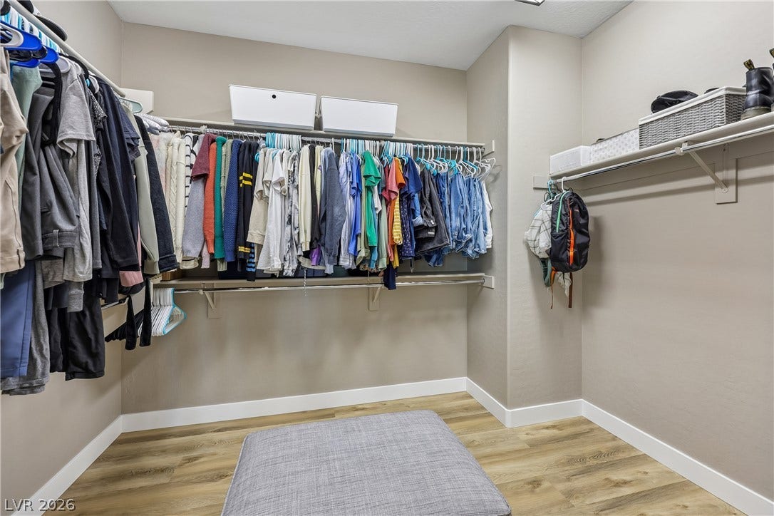 9490 Wild Valley Avenue, Las Vegas, NV 89148 Ample hanging rods and wood-look flooring maximize the utility of this closet space.