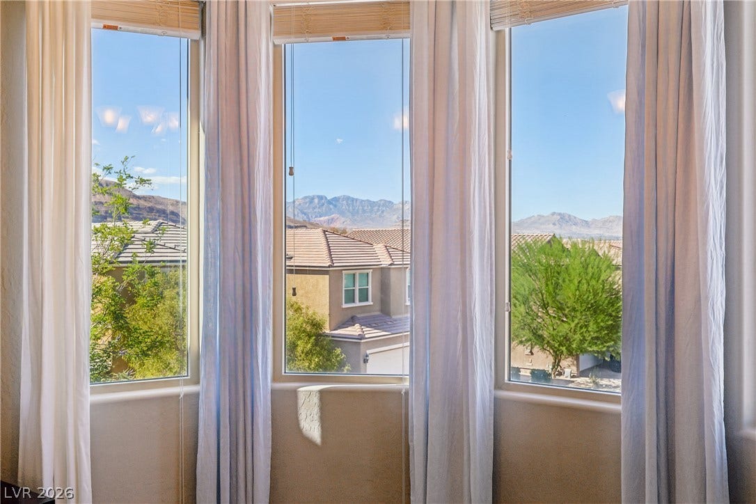 9490 Wild Valley Avenue, Las Vegas, NV 89148 Framed windows offer picturesque views of the surrounding neighborhood and distant mountains.