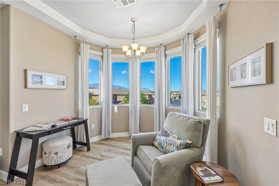 9490 Wild Valley Avenue, Las Vegas, NV 89148 Natural light pours through a curved wall of windows highlighting the tray ceiling detail.