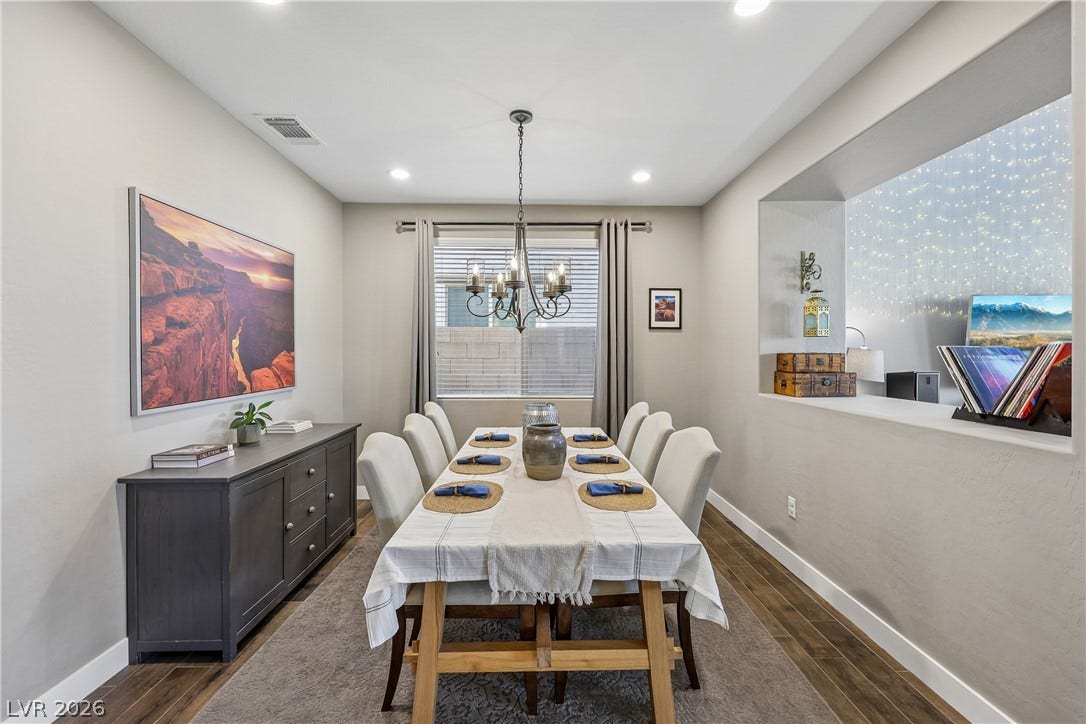 9490 Wild Valley Avenue, Las Vegas, NV 89148 Gleaming hardwood floors and a massive wall cutout define this inviting formal dining room.