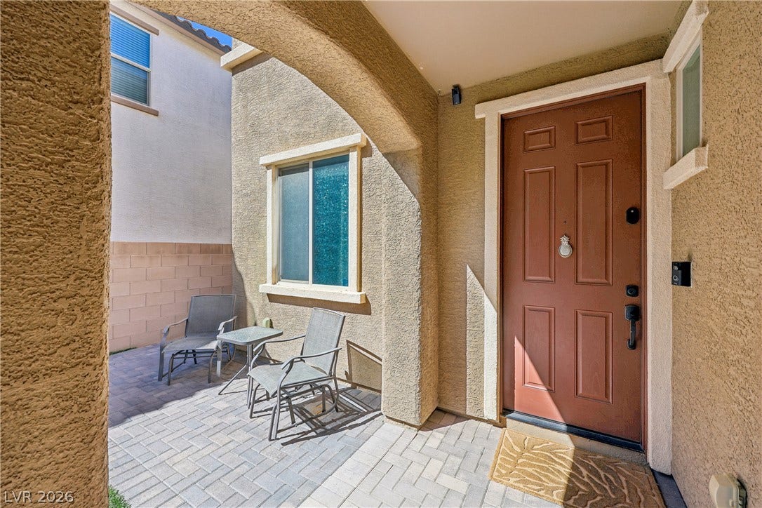 9490 Wild Valley Avenue, Las Vegas, NV 89148 An inviting stucco archway frames the brick-paved entry porch and private courtyard.