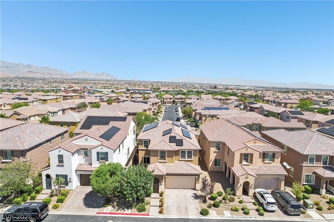 9490 Wild Valley Avenue, Las Vegas, NV 89148 An elevated perspective reveals tiled rooftops, integrated solar panels, and distant mountain backdrops.