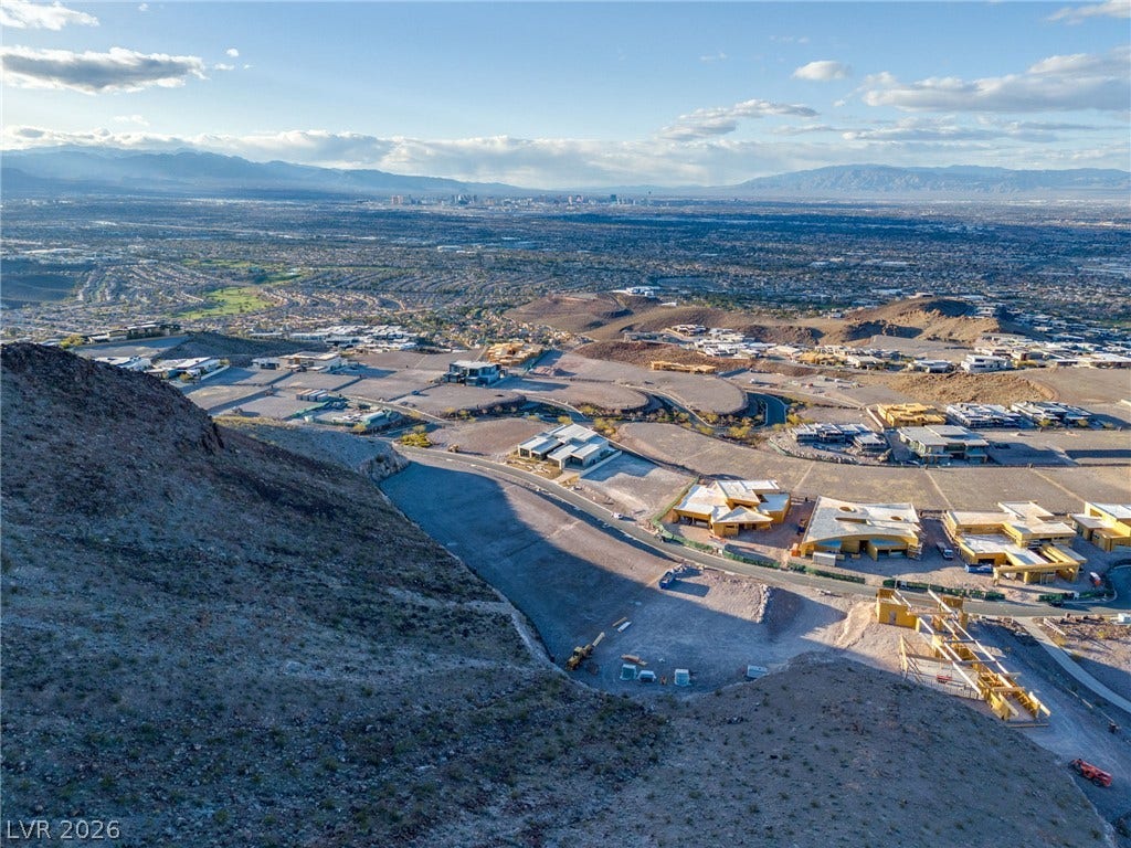7 Chisel Crest Court, Henderson, NV 89012 A sweeping panorama captures distant city views from a dramatic hillside setting.