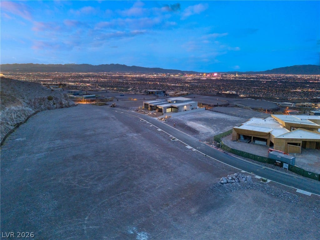 7 Chisel Crest Court, Henderson, NV 89012 Panoramic city lights and distant mountain views define this elevated hillside development parcel.
