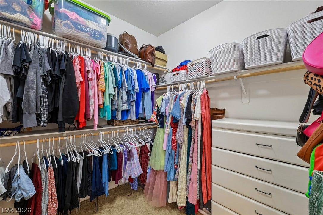 Ample hanging space and integrated drawers create an organized and functional walk-in closet.