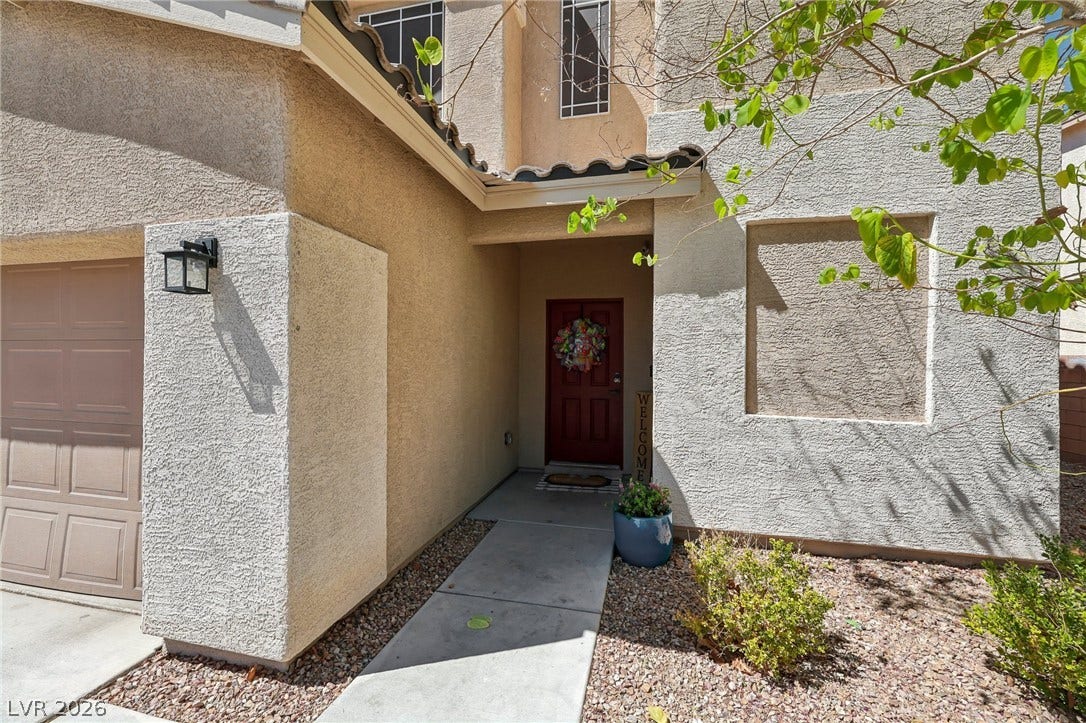 A welcoming entry, with clean lines and low-maintenance landscaping, creates appealing curb appeal.
