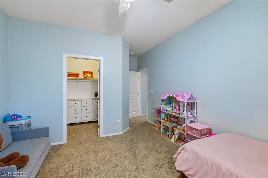 A well-lit bedroom features plush carpeting and convenient closet space, ready for personalization.