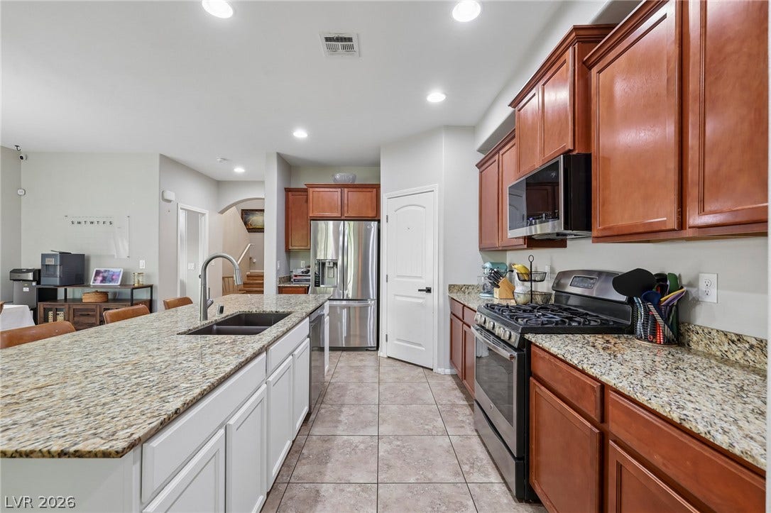 Culinary excellence awaits in this well-appointed kitchen, featuring a spacious island and gleaming stainless-steel appliances.