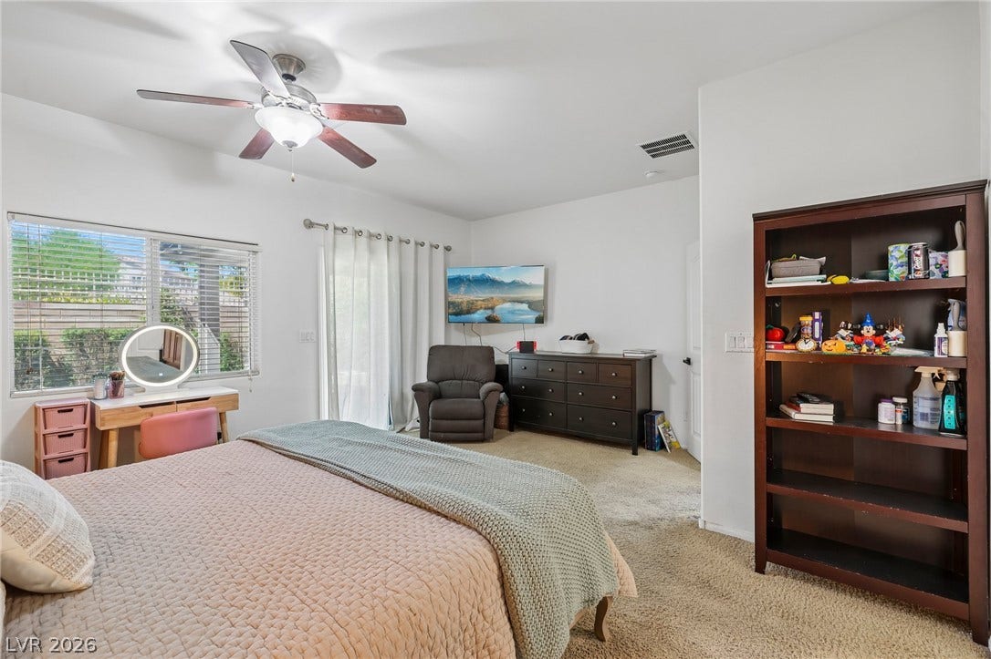 Well-lit sleeping quarters with a cooling ceiling fan and convenient direct outdoor access. Located downstairs