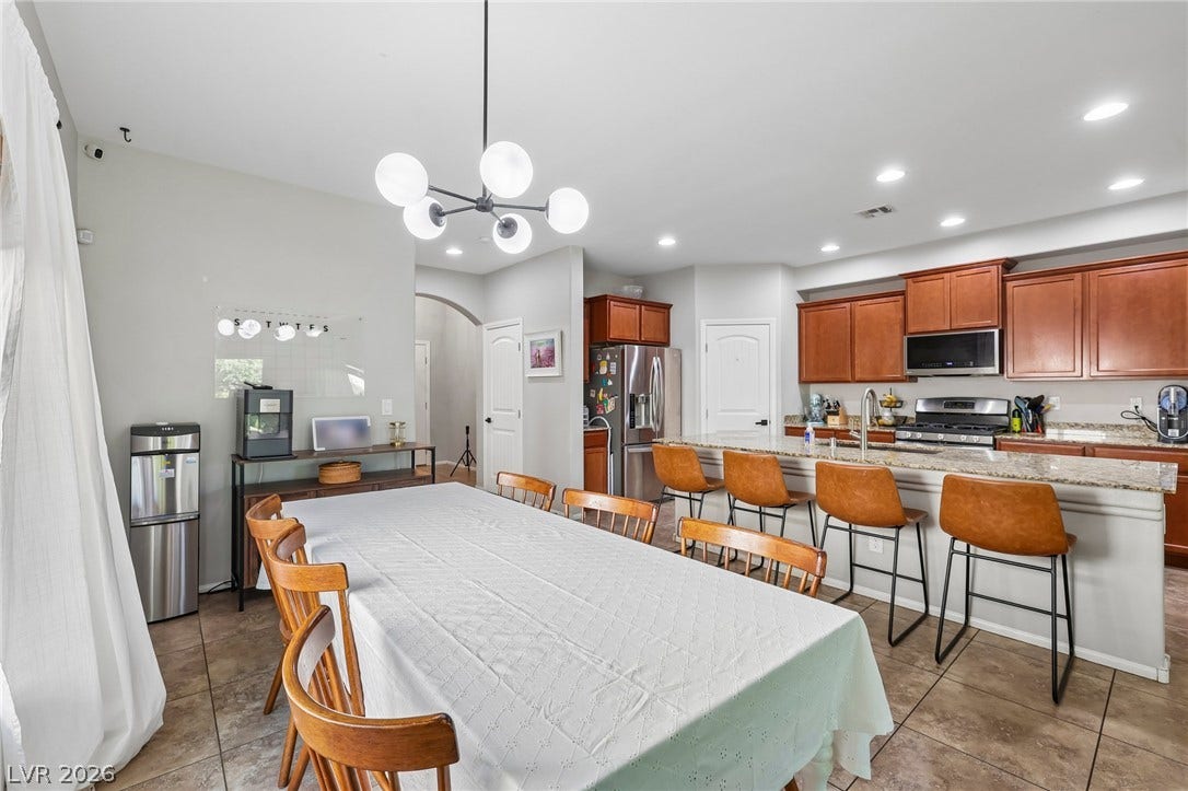 An inviting open-concept layout features a well-appointed kitchen flowing seamlessly into a spacious dining area.