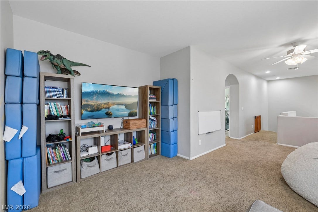 A versatile bonus room offers ample space for recreation and relaxation, complete with recessed lighting and soft carpeting.