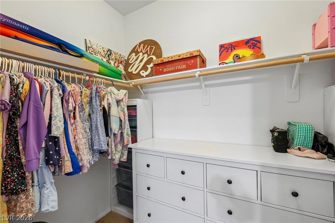 Ample hanging space and integrated drawers provide efficient storage solutions within this well-appointed closet.