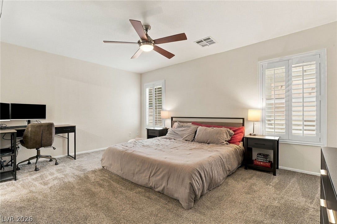 Plush carpet underfoot pairs beautifully with classic plantation shutters in this restful retreat.
