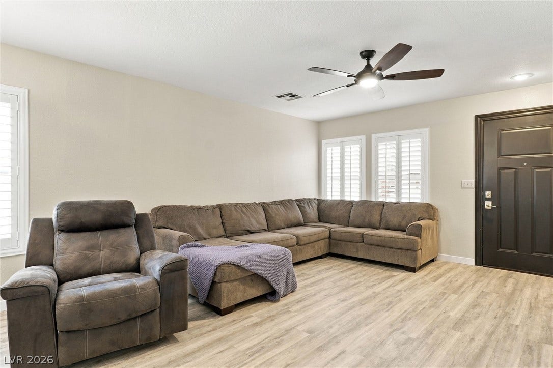 An inviting entryway transitions smoothly into a comfortable living space with durable vinyl plank flooring.