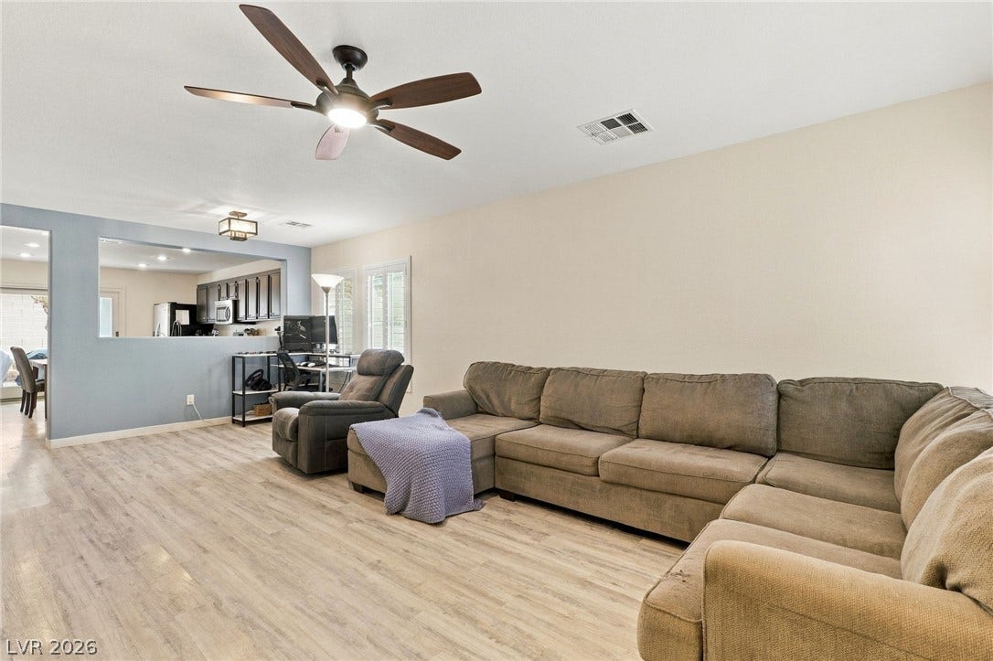 An open floor plan connects the living area seamlessly to the adjacent kitchen space.