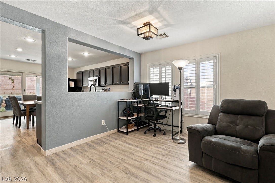 An open floor plan connects the comfortable living area directly to the kitchen.