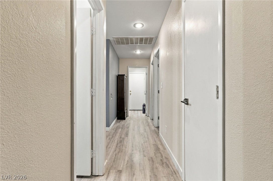 A long hallway connects rooms smoothly with clean architectural lines.