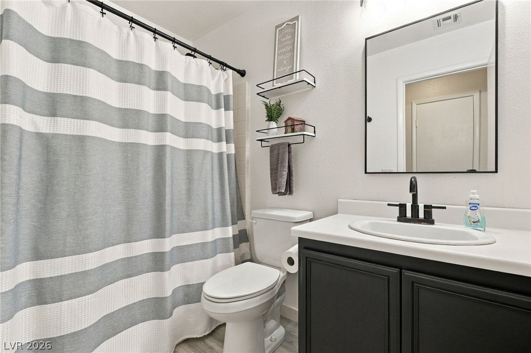 Clean lines and a modern vanity define this updated full bathroom.