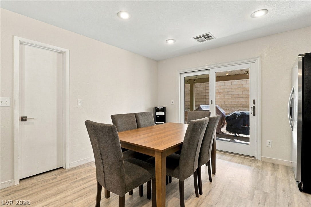 Sliding glass doors open directly to the outdoor patio from this inviting dining space.