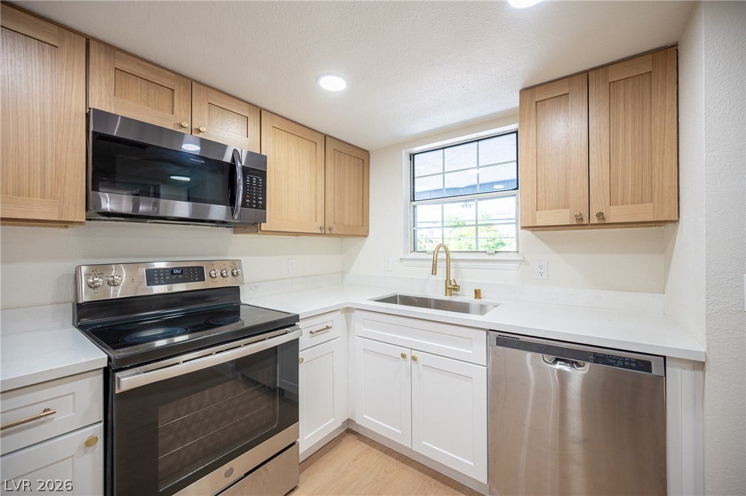 3823 S Maryland Parkway, #B11, Las Vegas, NV 89119 Natural light beams through the window over a modern kitchen with updated stone counters.