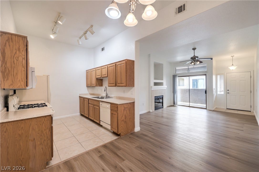 Gleaming wood-look floors connect a classic kitchen with a light-filled living area.