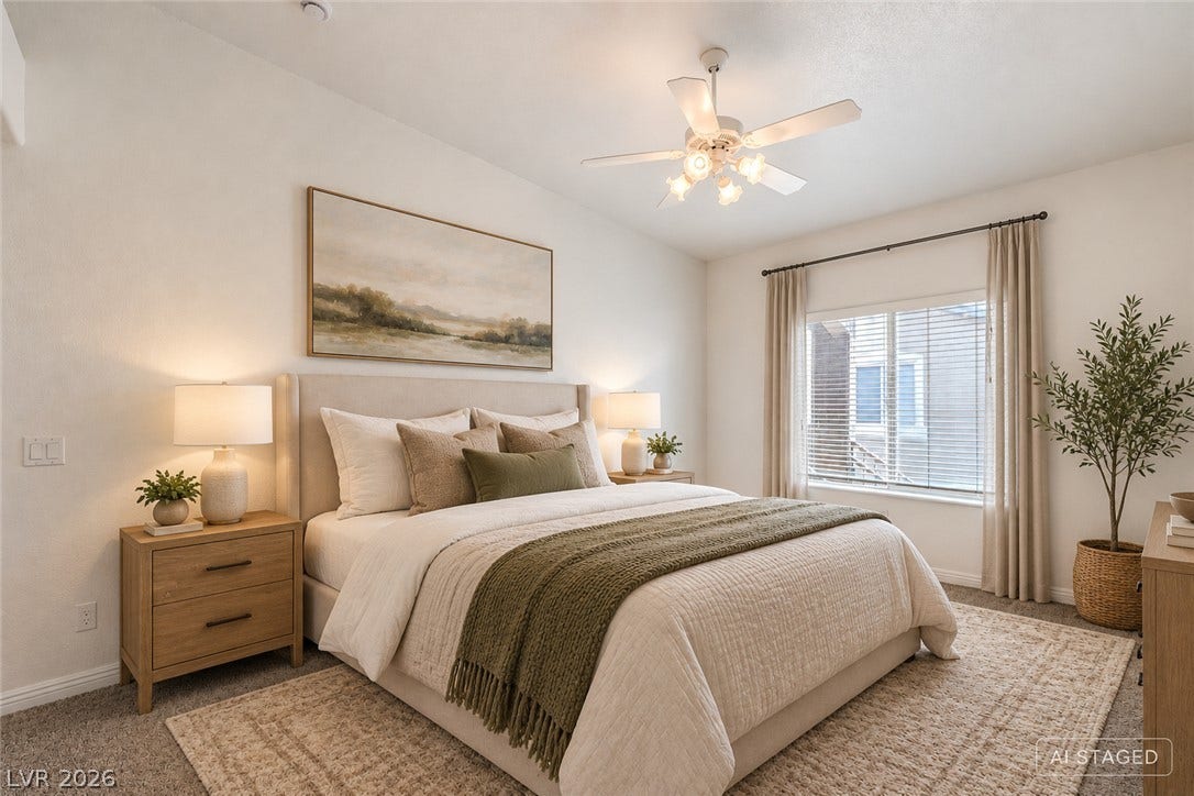 A wide window illuminates the serene bedroom featuring plush wall-to-wall carpeting.