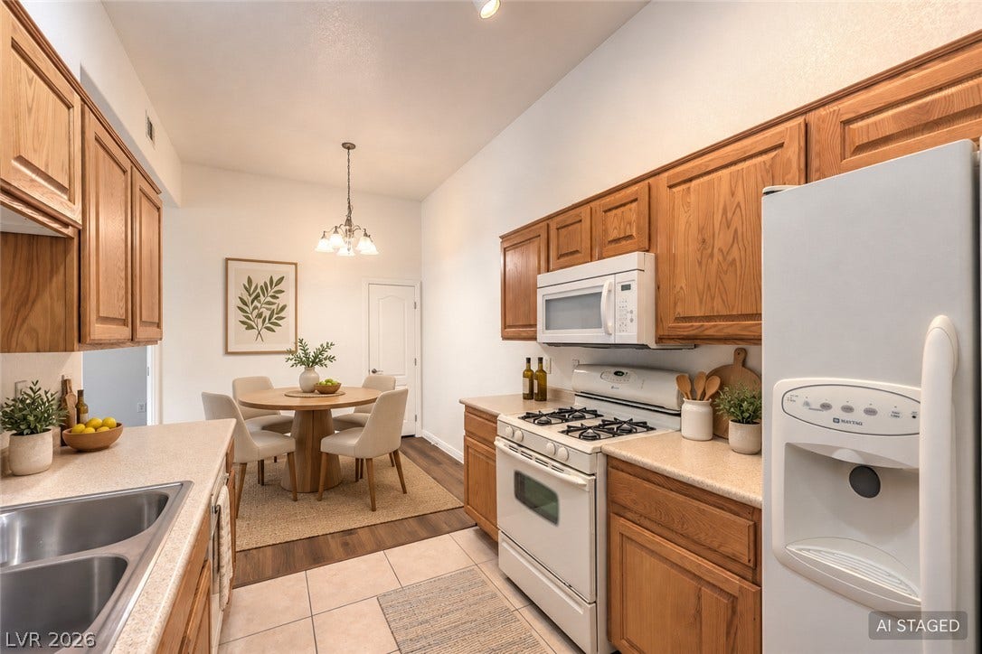 Natural oak cabinetry and durable tile flooring define this functional kitchen layout.