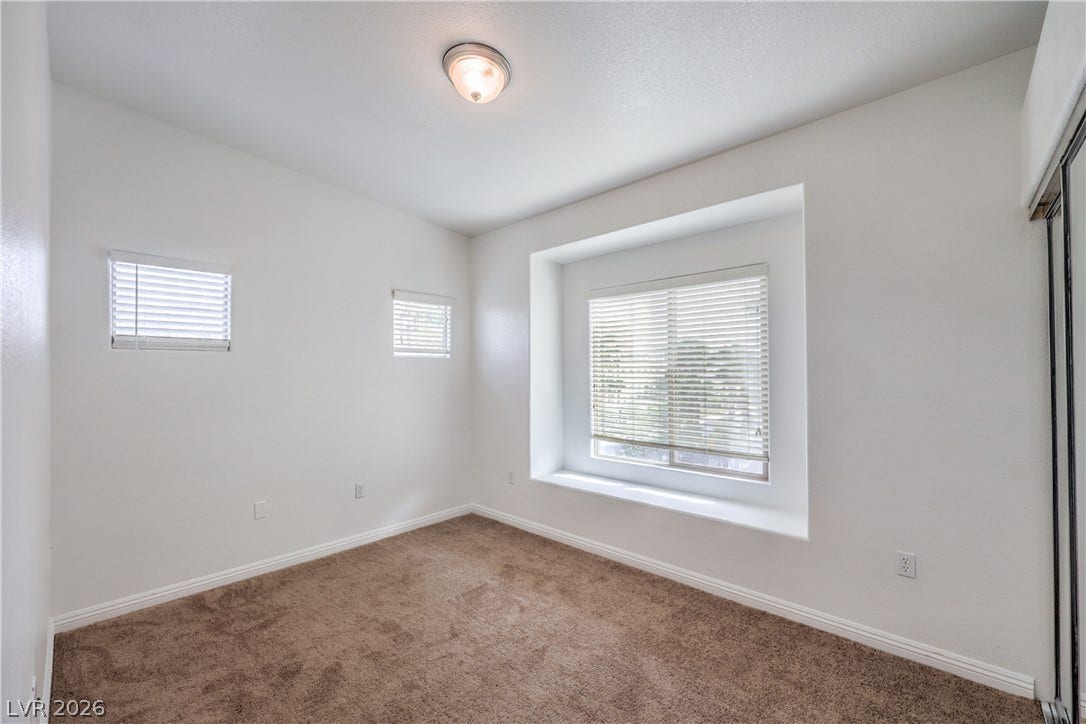 Plentiful natural light streams through a deep window seat and matching side windows.