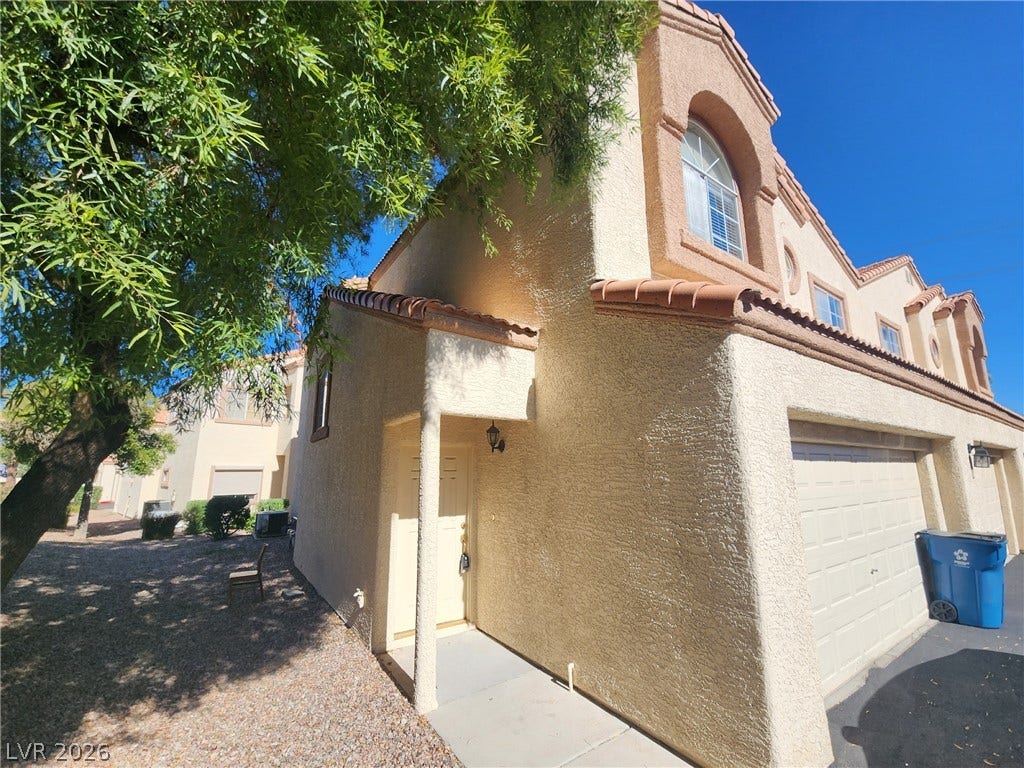 8301 Boseck Drive, #237, Las Vegas, NV 89145 Classic Mediterranean styling defines this multi-level stucco exterior featuring a tiled roofline and attached garage.