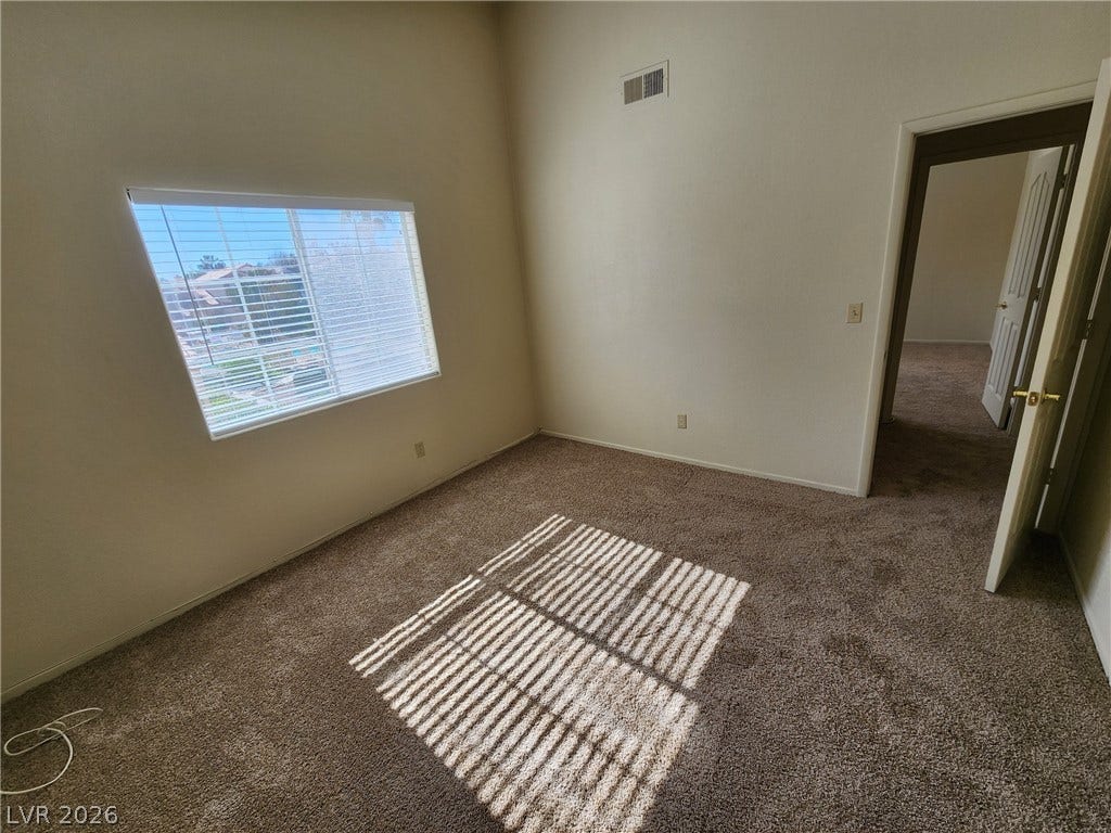 8301 Boseck Drive, #237, Las Vegas, NV 89145 High ceilings and soft carpeting define this inviting secondary bedroom space.