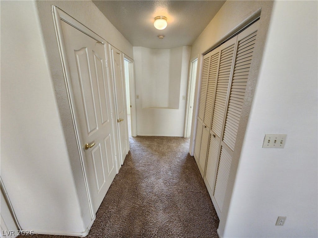 8301 Boseck Drive, #237, Las Vegas, NV 89145 Soft carpeting lines the hallway leading to multiple rooms and convenient storage closets.