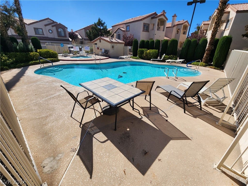 8301 Boseck Drive, #237, Las Vegas, NV 89145 A pristine community swimming pool is surrounded by a spacious concrete deck and manicured landscaping.