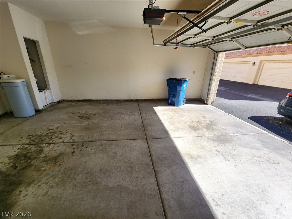 8301 Boseck Drive, #237, Las Vegas, NV 89145 A spacious garage features durable concrete flooring and an automatic overhead door opener.