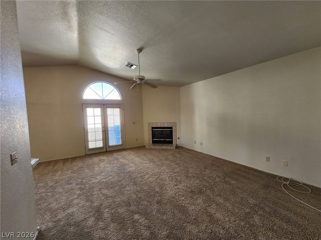 8301 Boseck Drive, #237, Las Vegas, NV 89145 High vaulted ceilings and a corner fireplace anchor this inviting living space.