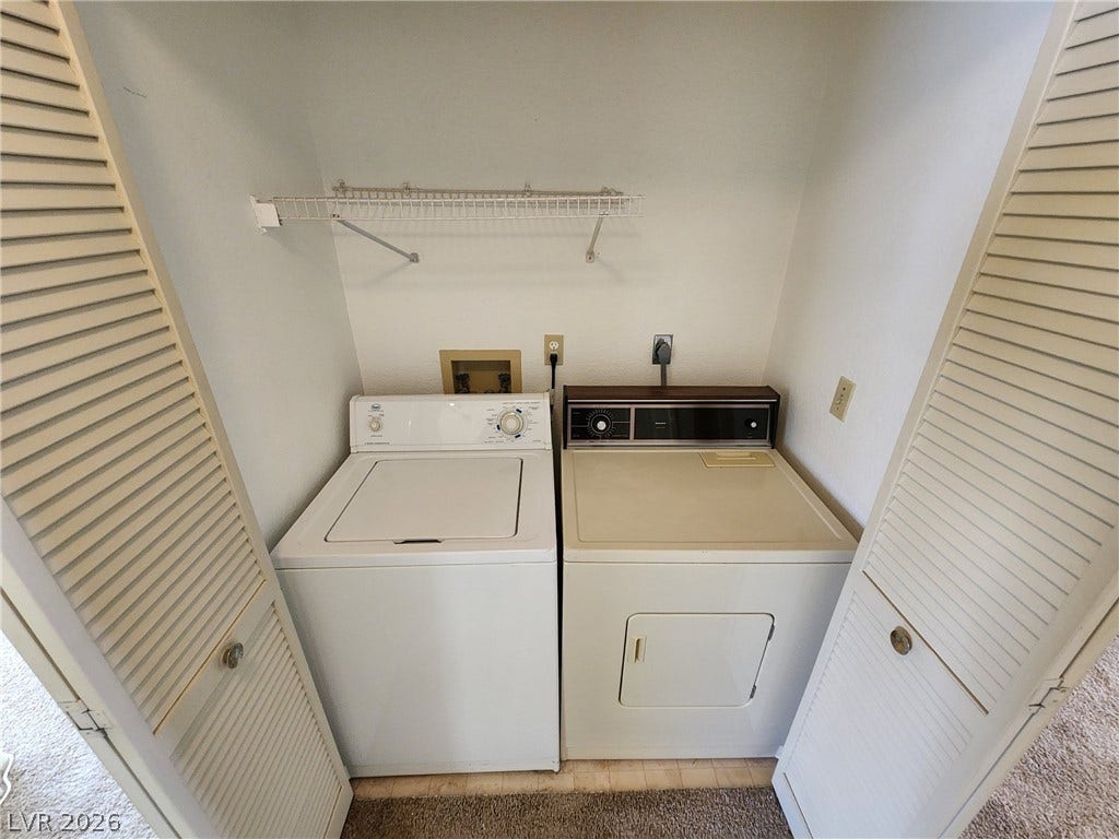 8301 Boseck Drive, #237, Las Vegas, NV 89145 Functional laundry closet features a dedicated washer and dryer setup behind folding louvered doors.