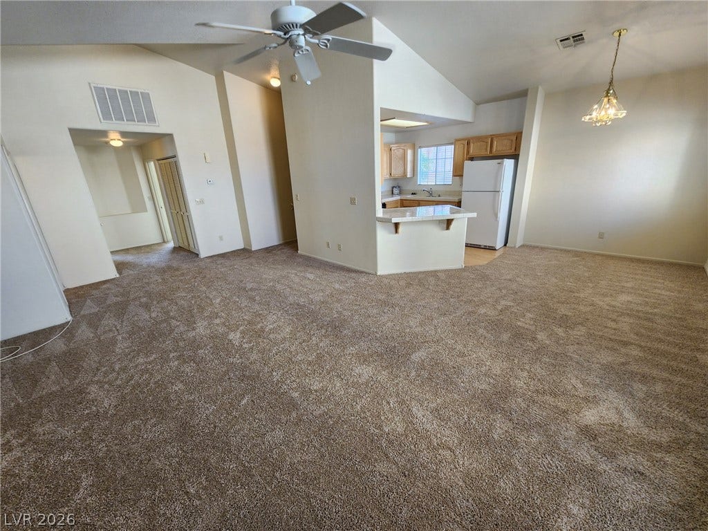 8301 Boseck Drive, #237, Las Vegas, NV 89145 An open layout flows from carpeted living spaces into the functional kitchen.