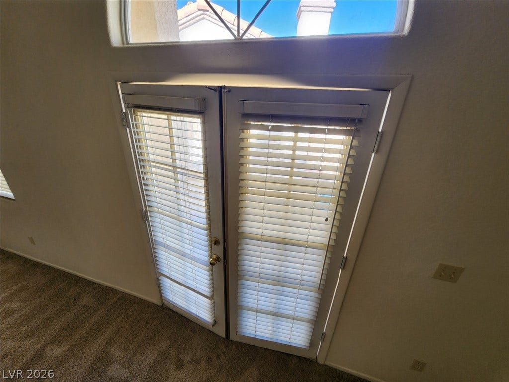 8301 Boseck Drive, #237, Las Vegas, NV 89145 Double doors open to the outdoors under a classic arched transom window.