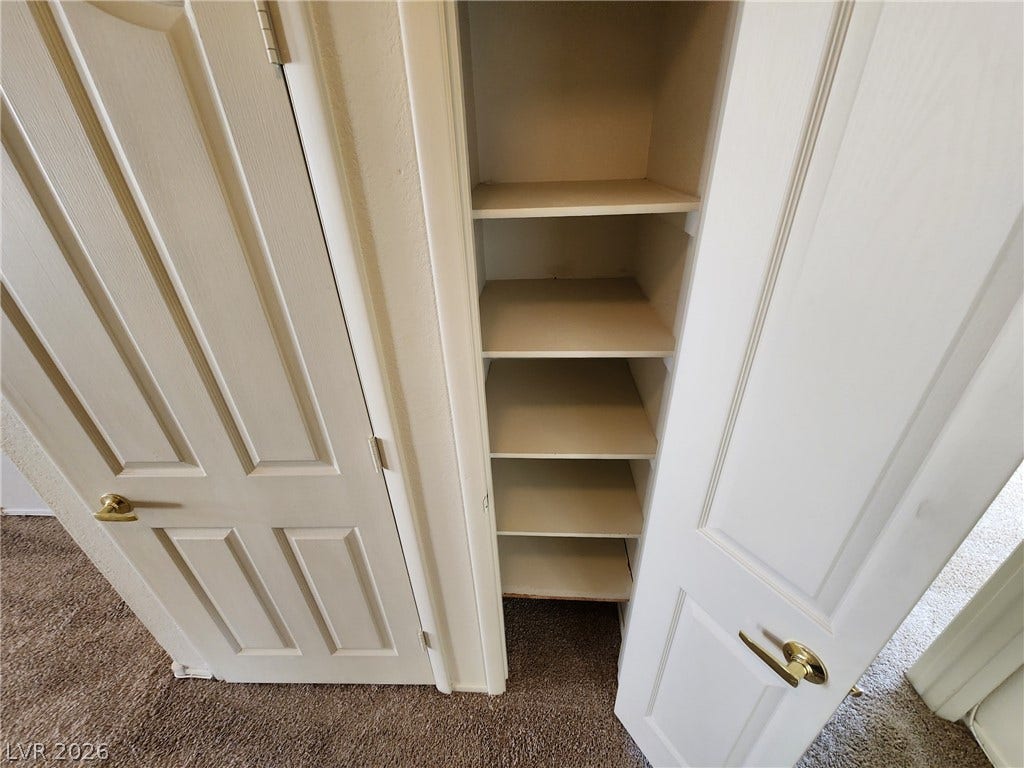 8301 Boseck Drive, #237, Las Vegas, NV 89145 Ample built-in shelving provides convenient storage space within this hallway closet setup.