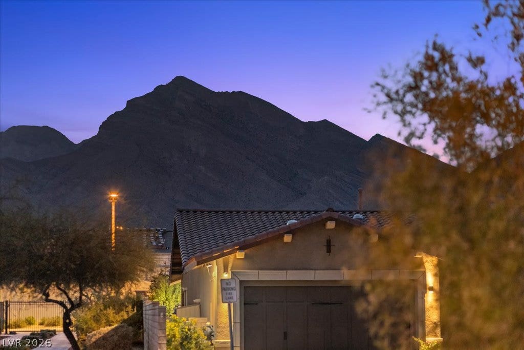 286 Besame Court, Las Vegas, NV 89138 Dramatic mountain peaks rise sharply behind the tiled roofline of this desert home.