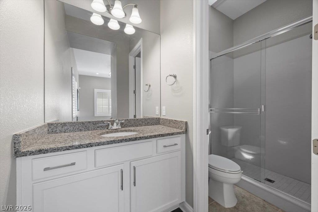 286 Besame Court, Las Vegas, NV 89138 Granite counters and a glass-enclosed shower highlight this modern bathroom space.
