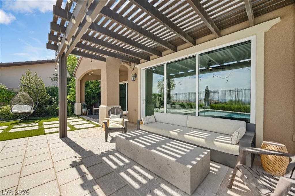 286 Besame Court, Las Vegas, NV 89138 An inviting stone-paved patio nestles beneath a handsome wooden pergola.