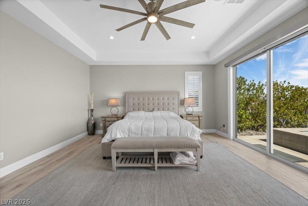 286 Besame Court, Las Vegas, NV 89138 Sliding glass doors open directly to the outdoors from this wood-floored bedroom.