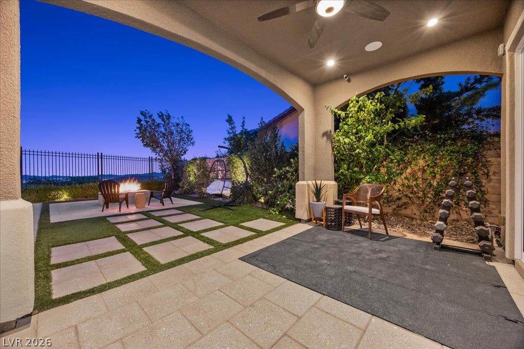 286 Besame Court, Las Vegas, NV 89138 A spacious covered patio transitions seamlessly to paver stones and a custom fire pit.