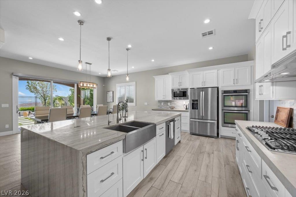 286 Besame Court, Las Vegas, NV 89138 Gleaming stone countertops and modern appliances anchor this expansive culinary space.