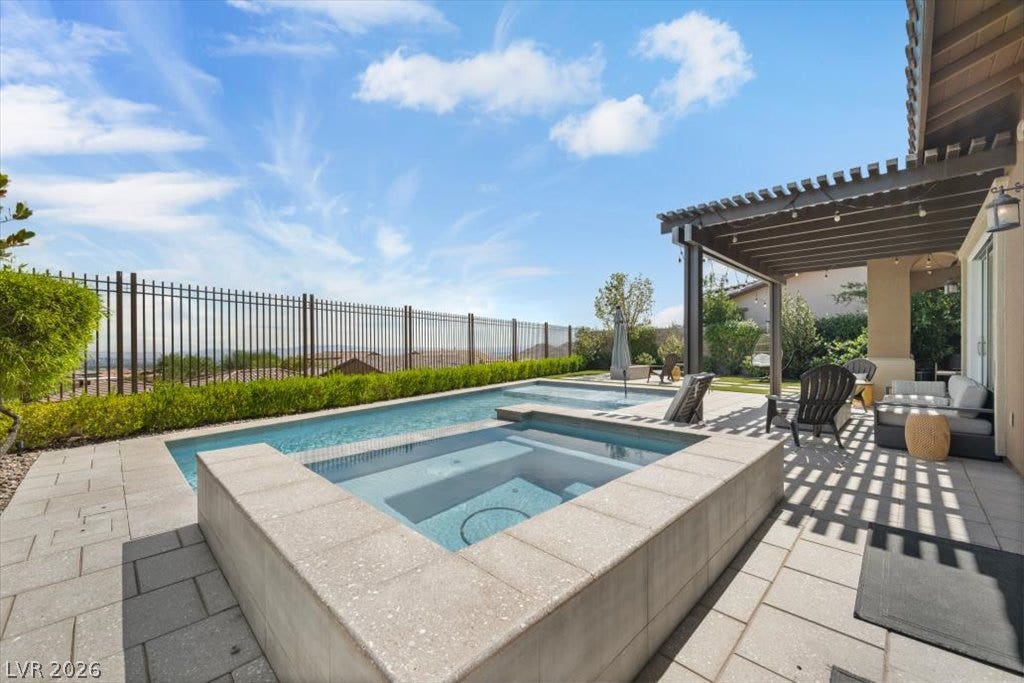 286 Besame Court, Las Vegas, NV 89138 An inviting backyard oasis features a clean-lined pool and spa bordered by stone paving.