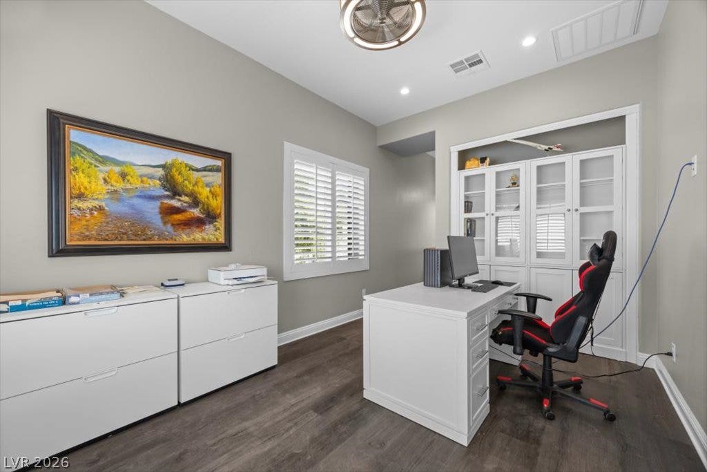 286 Besame Court, Las Vegas, NV 89138 Rich wood-look flooring and custom built-in cabinetry define this quiet home office space.
